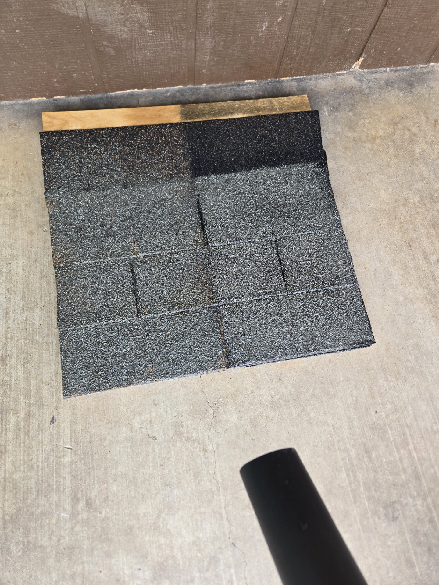 Treated shingle sample with Black & Decker blower nozzle — 250 MPH wind test, zero granule loss